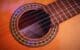 closeup photography of brown acoustic guitar
